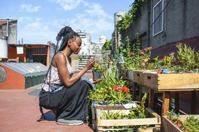 woman on rooftop urban garden