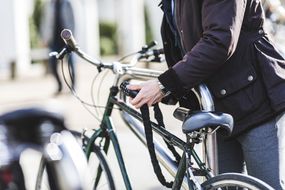 Woman locking bike to rack