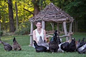 凯西·谢伊·莫尔米诺在院子里和鸡在一起
