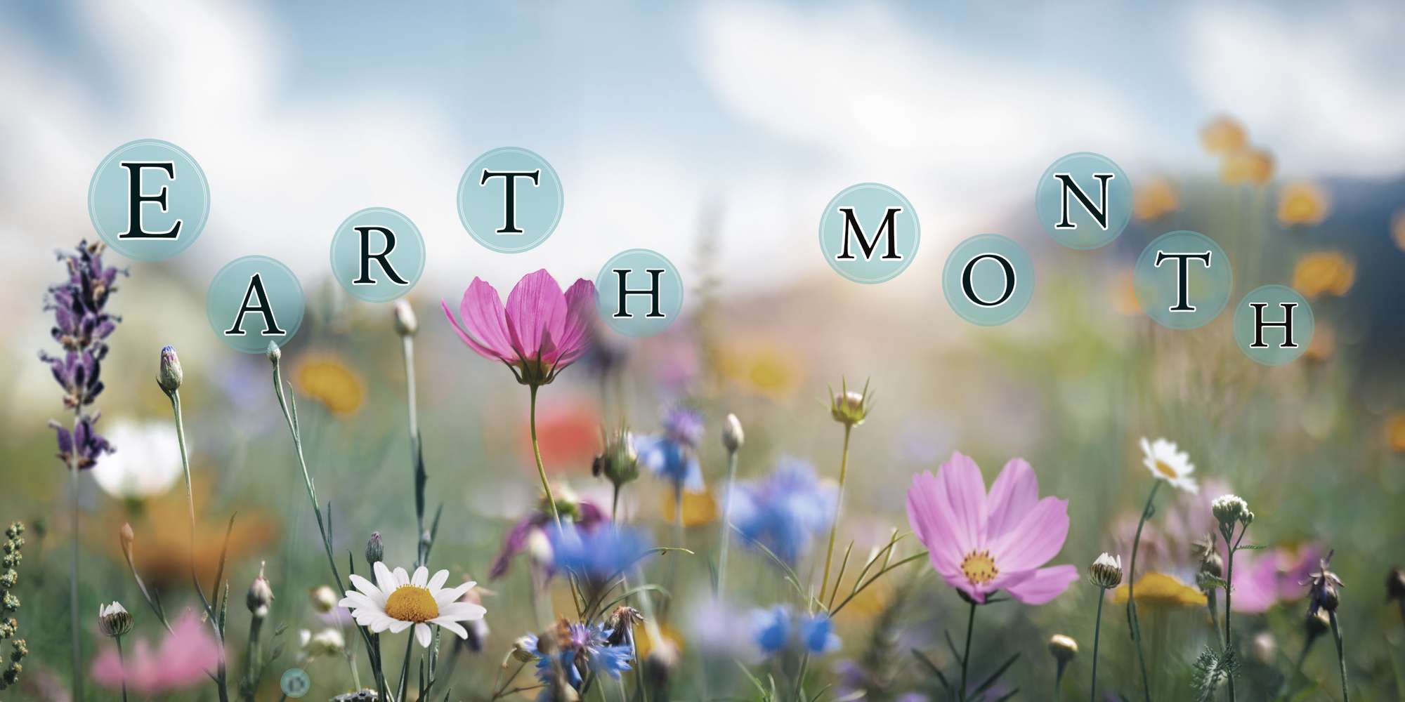 Earth Month written over an image of a meadow