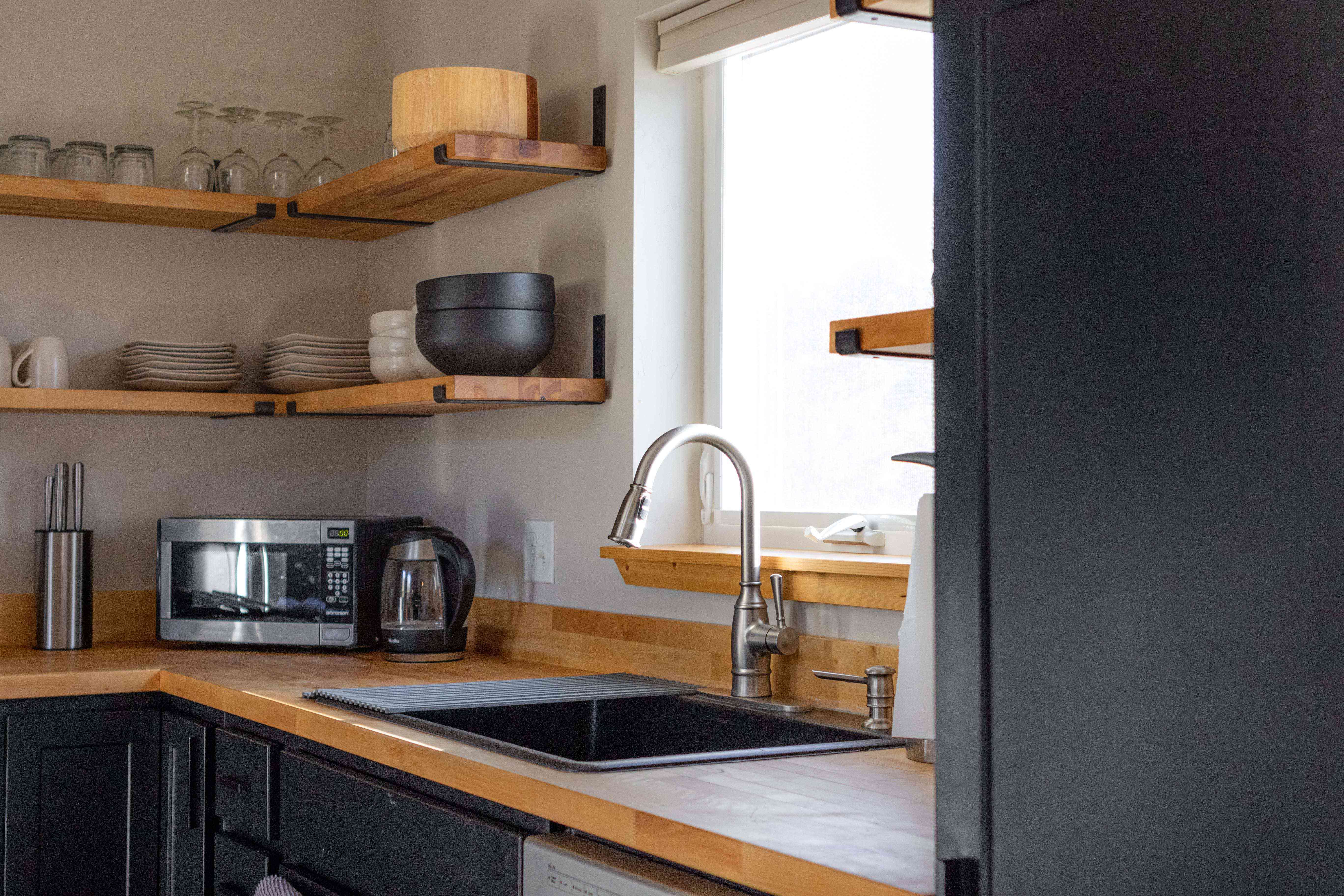 极简主义厨房，裸露的木架子和哑光黑色架子