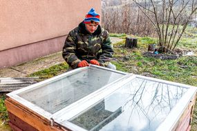 男人为菜园建造一个冷框架