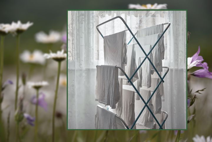 Photo of clothes drying on rack over a photo of a meadow