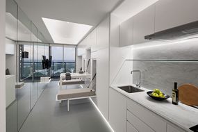 K-Thengono Design Studio设计的3合1公寓室内设有用餐区
