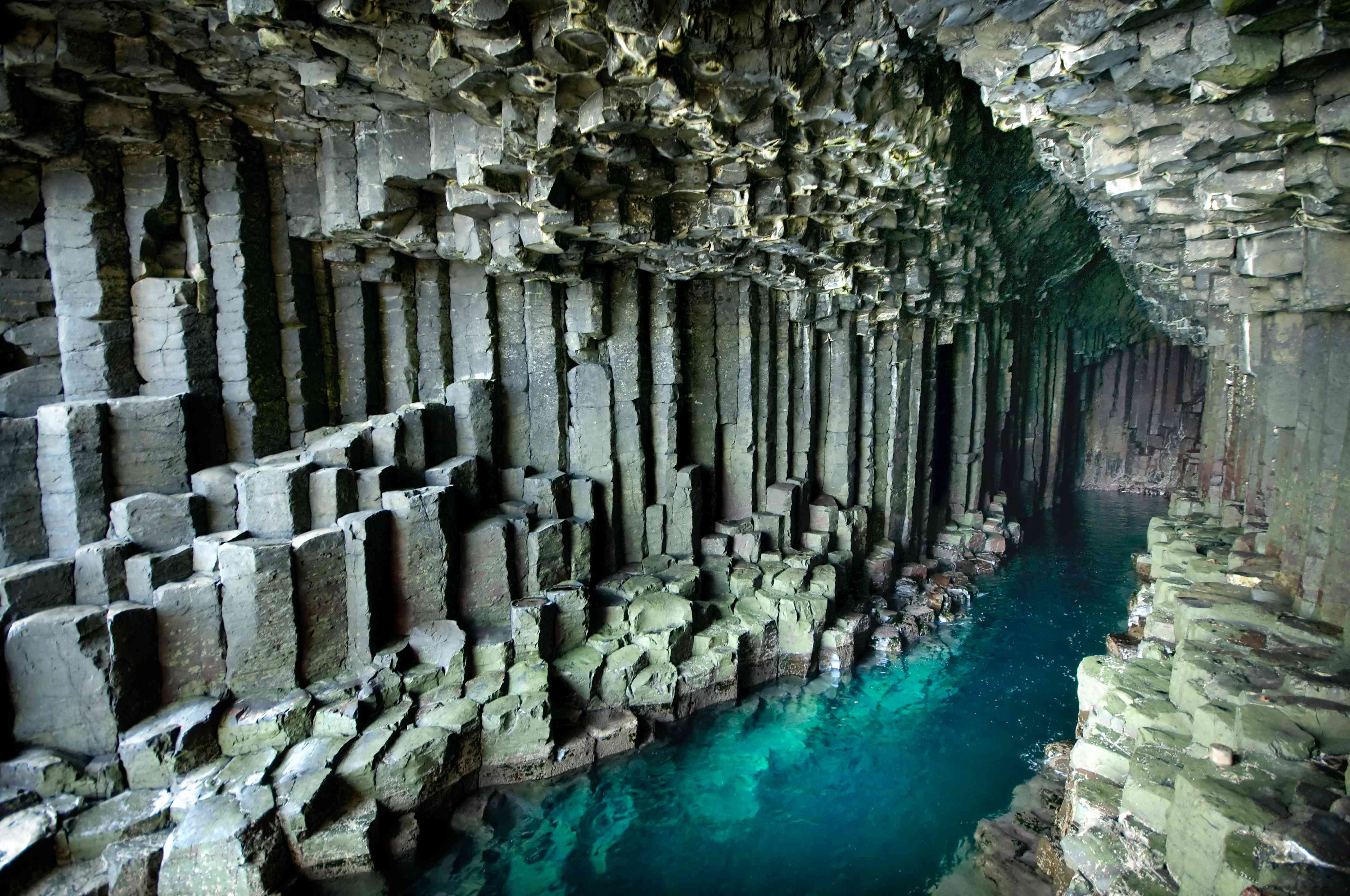芬格尔洞穴的玄武岩柱从蓝色的海水中拔地而起