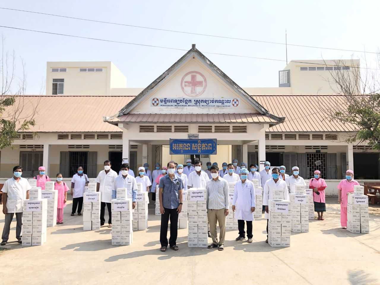 医疗保健工人在大流行期间在设施外戴口罩，并在柬埔寨捐赠了肥皂
