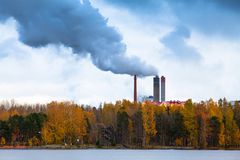 工厂烟气排放从湖泊和森林后面