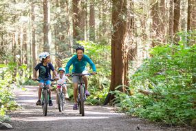 Family biking in the forest
