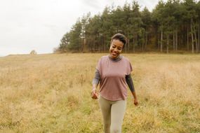 Happy woman takes a walk in nature