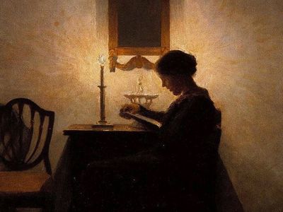 烛光（1908）的女人阅读。彼得·伊尔斯特（Peter Ilsted）（丹麦语，1861- 1933年）