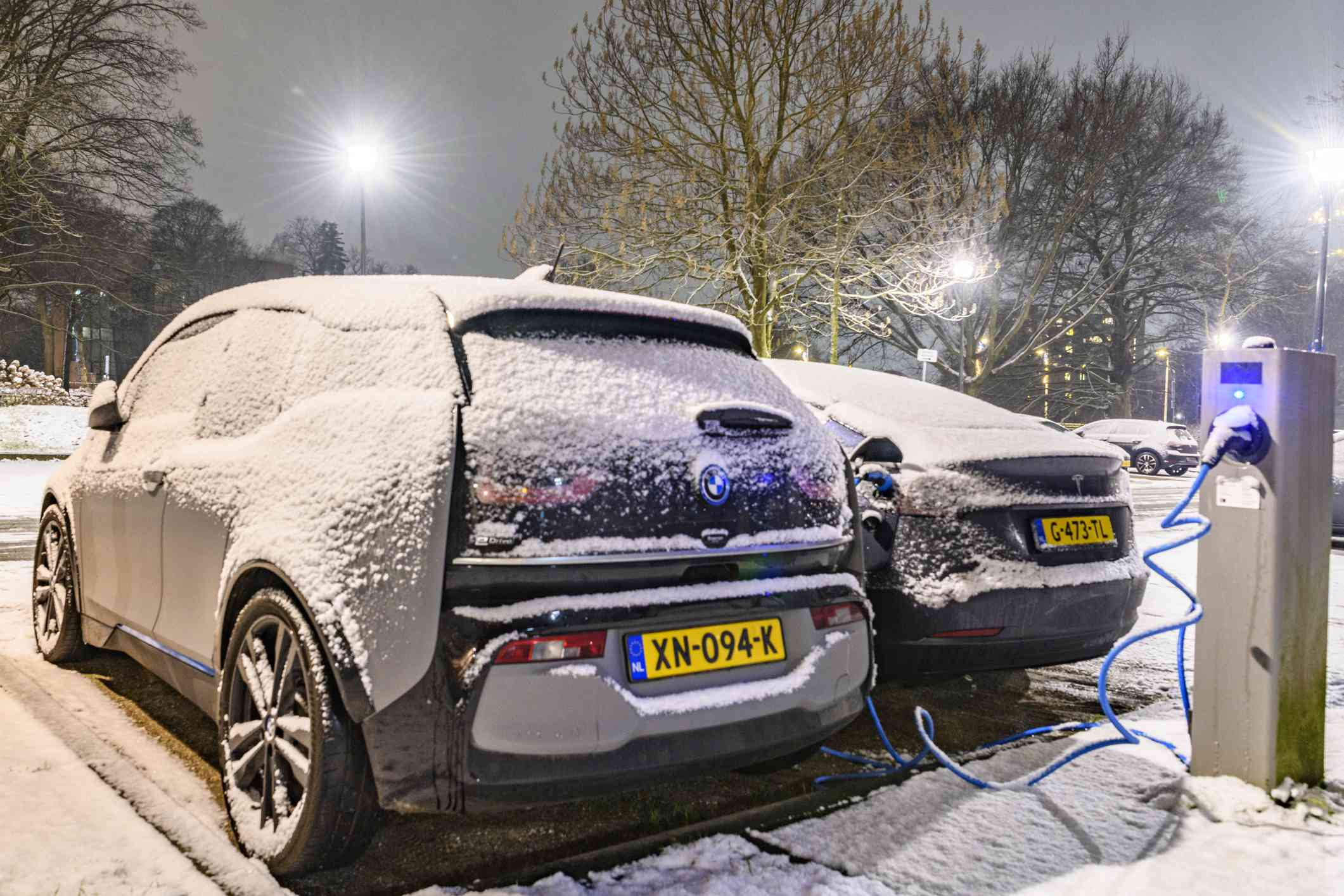荷兰Zwolle的雪中充电的电动汽车“width=