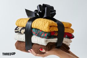一堆叠好的毛衣包裹在一个黑色的蝴蝶结里