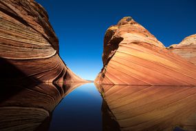 A red sandstone formation against a dark blue sky