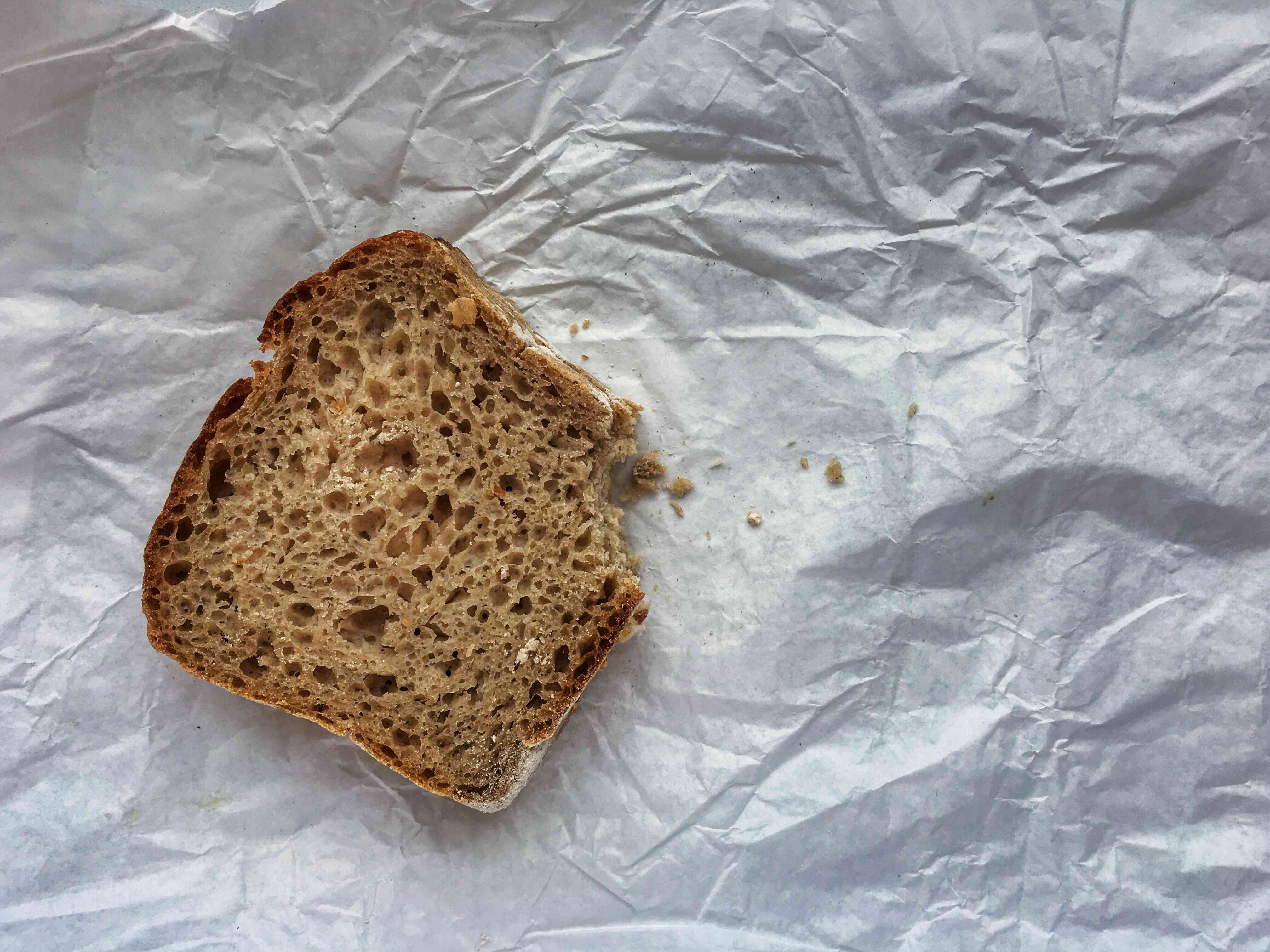 高角度看法的被吃的面包在被弄皱的纸