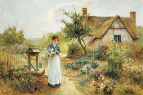 女人在传统英国小屋花园里的绘画