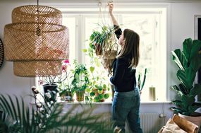 Woman hanging planter