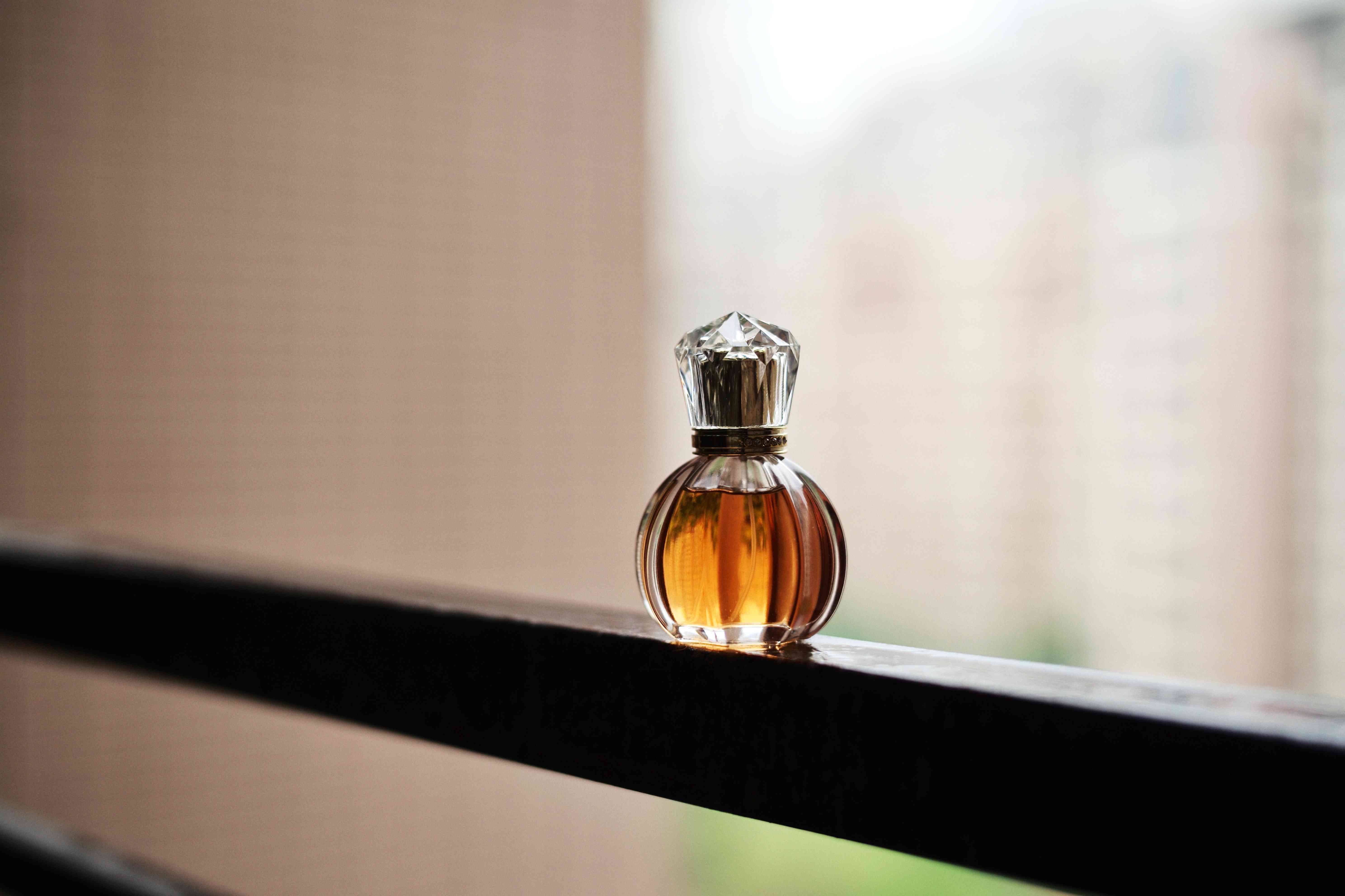一瓶香水在窗台上”width=
