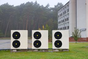 Air source heat pumps in front of an apartment building