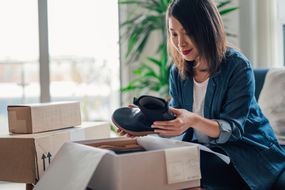 Woman opening box of shoes