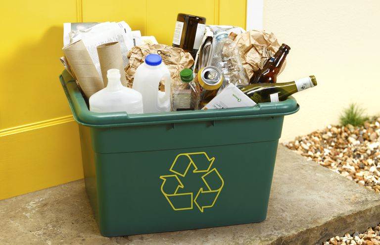 室外的绿色回收箱里装满了塑料和玻璃瓶